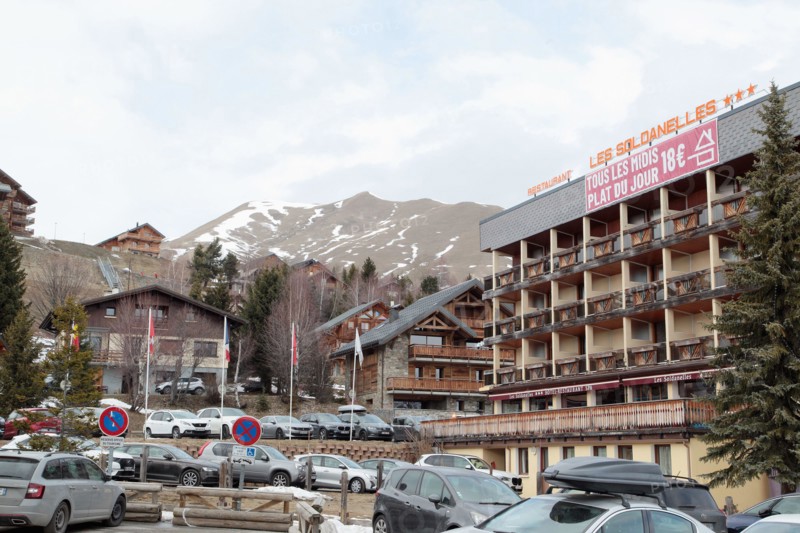 La Toussuire ski resort in Maurienne valley, French Alps, winter season with limited snow and apartment buildings, Savoie, France