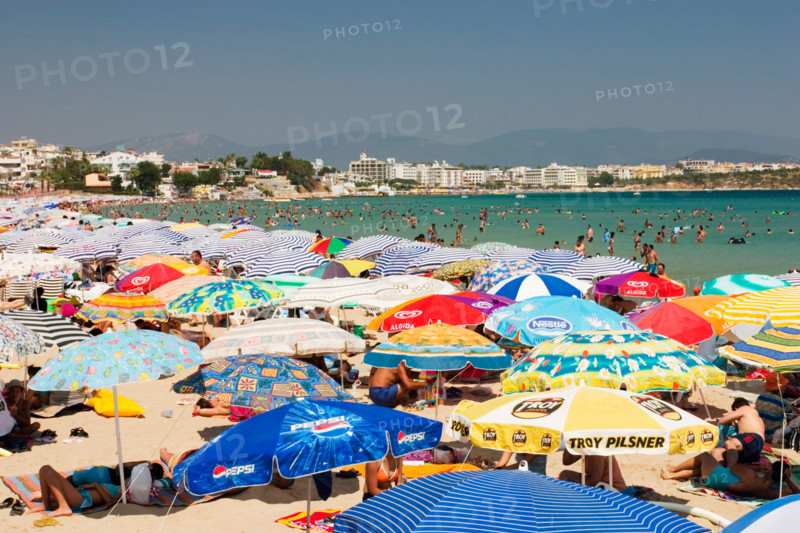 Overcrowded beach covered with sun umbrellas - Didim Altinkum, Turkey