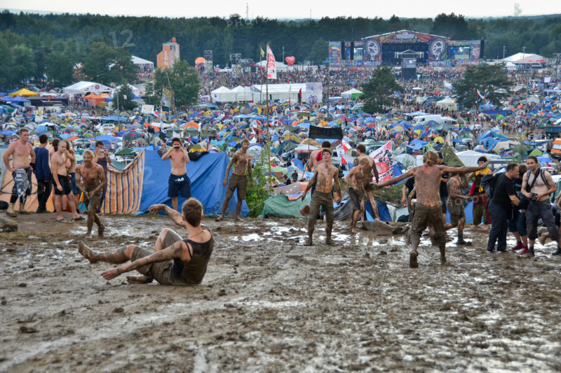 KOSTRZYN NAD ODRA, POLAND - AUGUST 4: Festival Przystanek Woodstock - fans bath in the mud in front camping  on August 4, 2012 i