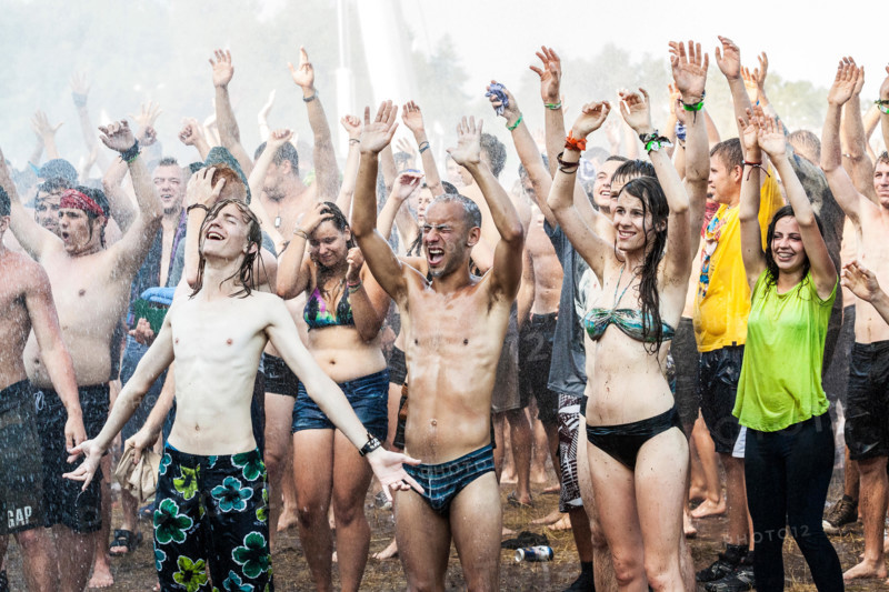 People enjoying water curtain at the19th Przystanek Woodstock (Woodstock Festival).