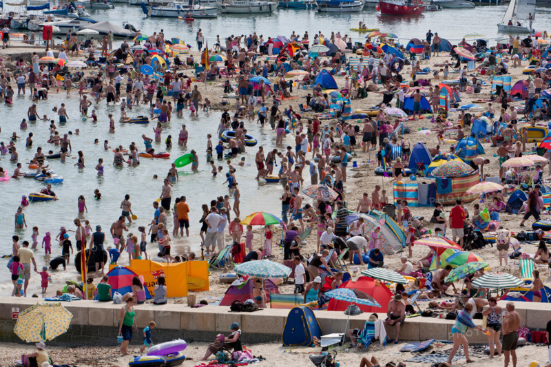 Lyme Regis, United Kingdom - July, 28 2008: Packed summer beach at Lyme Regis on the Dorset Coast