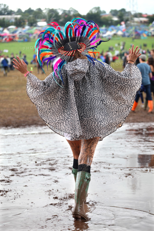 A young woman struggles through the mud at the 2014 Glastonbury Festival.