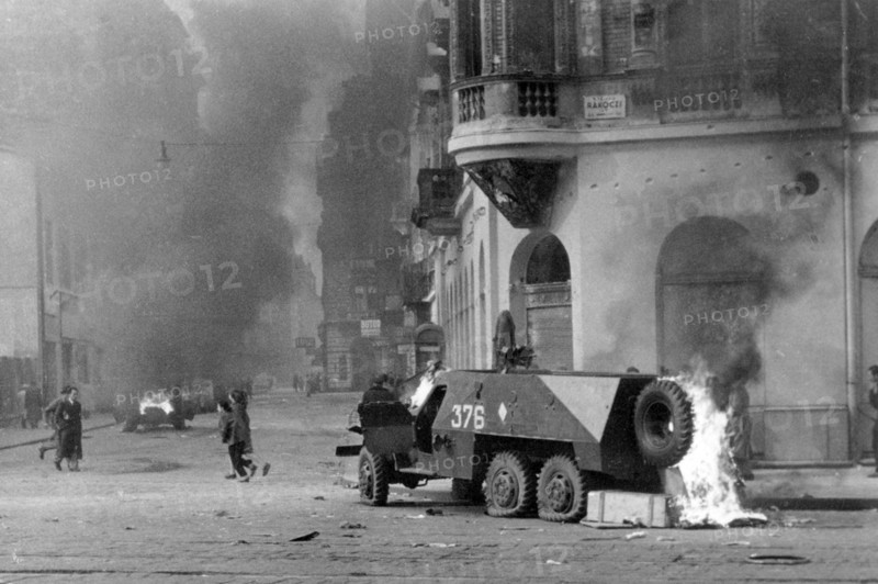 A Soviet-built BTR-152 armored personnel carrier burns on a Budapest street, November 1956  during the 1956 Hungarian Revolution.