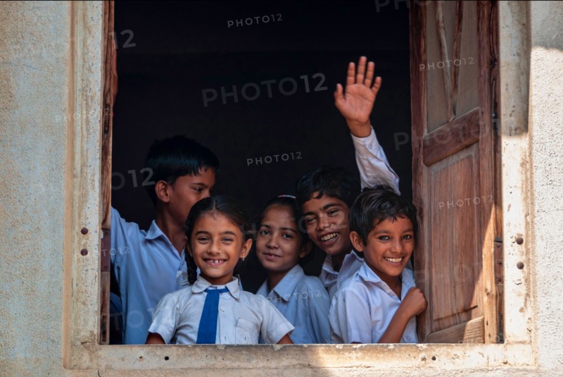 Children looking thru the window in school in Fatehpur, Rajasthan, India