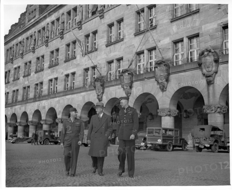 Original Caption: "Shown leaving the Palace of Justice at Nurenburg, are left to right: Col. Charles W. Mays, Columbia, Mo., Marshal of the Military Tribunals; Judge Robert M. Toms, Detroit, Michigan, Presiding Judge of the Second Tribunal; and Lt. Col. William Turner, Deputy Courts Marshal, of Philadelphia, Pa.". 1946 - 1949. Photographs Relating to the Minor Nuremberg Trials