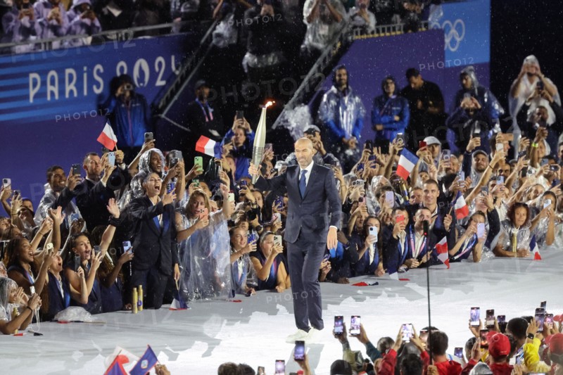 July 26th, 2024 - Paris, France: Zinedine Zidane of France carries the Olympic Torch during the Opening Ceremony of the Paris 2024 Olympics (photo by