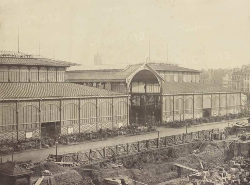Photograph showing pavilions of Les Halles, the central market of Paris, including outdoor vendors and new construction in the foreground. Paris. 1867
