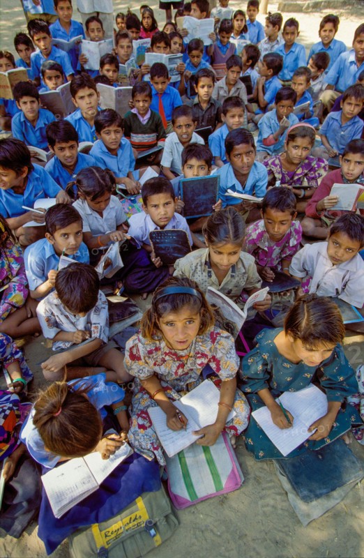 India, Rajasthan, primary school class having lessons outside between Jodhpur and Jaipur.
