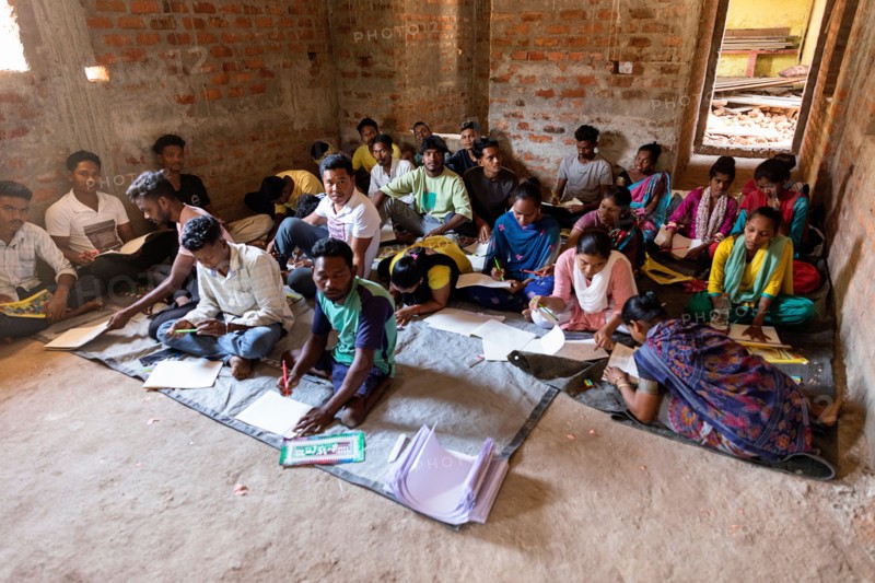 Young people learning to draw traditional symbols of animals in a culture of Lanjia saura tribe in orissa, india,classroom, school in abandoned house
