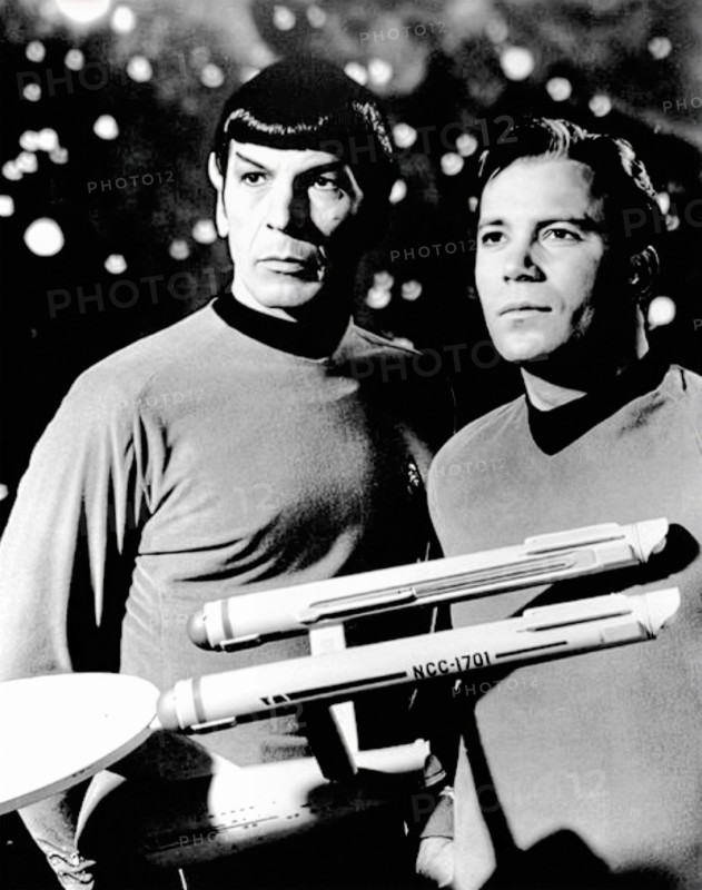 This 1968 publicity still features Leonard Nimoy as Spock and William Shatner as Captain James T. Kirk from the original Star Trek television series. The black and white photograph captures the iconic duo in their Starfleet uniforms, with Spock holding a model of the USS Enterprise.