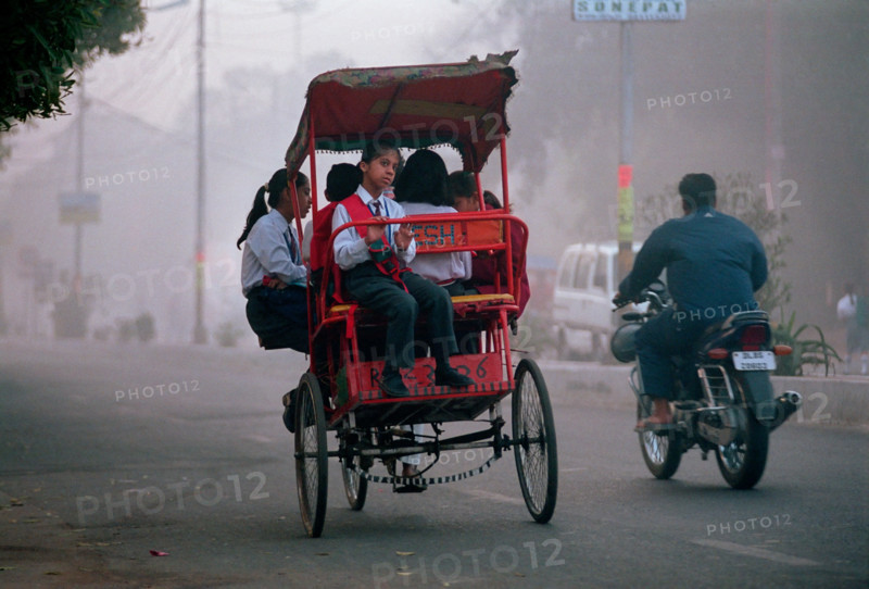 A cycle rickshaw full of school-children