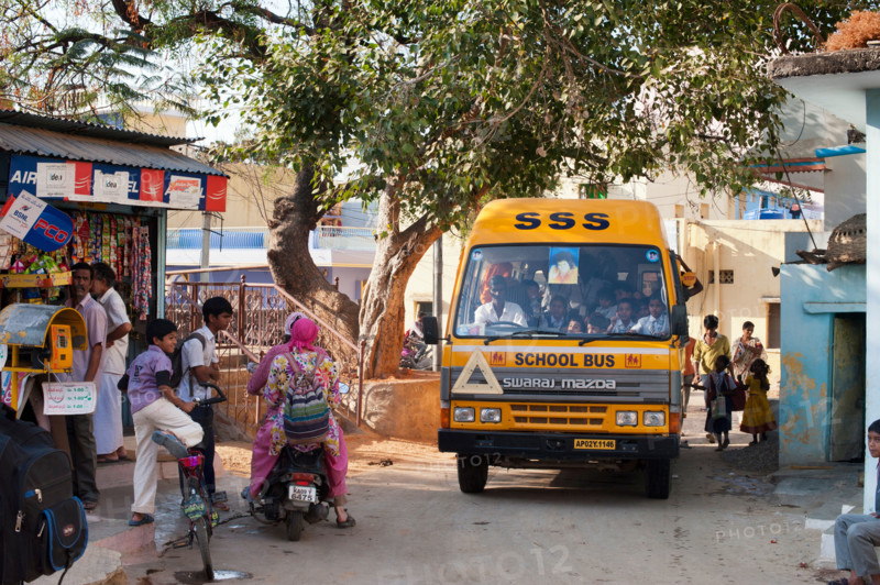 Indian school bus going through the indian town Puttaparthi. Andhra Pradesh, India