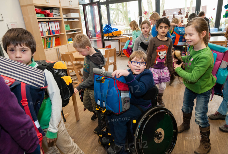 Non-disabled and disabled students (in this case a boy in a wheel chair) learn together in the same class in a primary school.