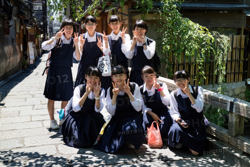 Kyoto, Japan - May 18, 2017: Group of pupils in school uniform on a trip in Kyoto are posing for a picture