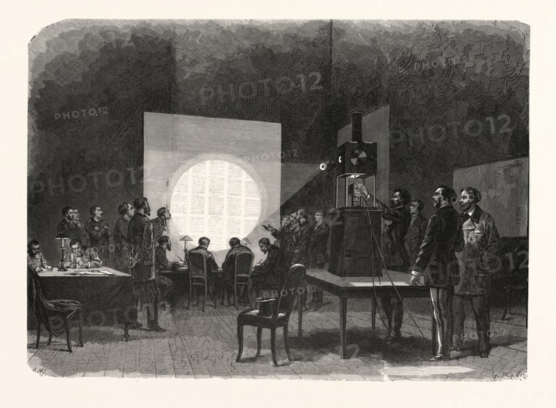 Franco-Prussian War: A despatch brought by a carrier pigeon from the province is deciphered at the telegraph office by an electrically illuminated enlarger