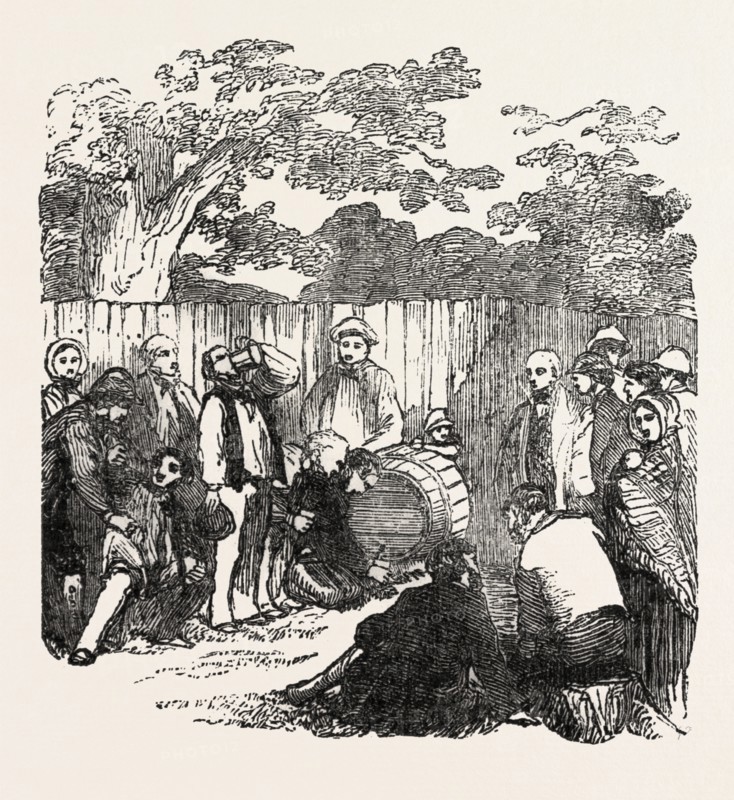 DRINKING THE BARREL OF BEER AT RICKMANSWORTH, HERTFORDSHIRE, UK