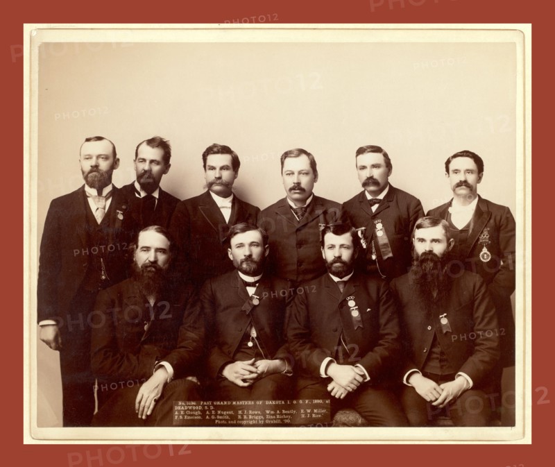 Past Grand Masters of Dakota I.O.O. F., 1890, at Deadwood, S.D. A.E. Clough, A.E.Nugent, H.J. Rowe, Wm. A. Bently, F.W. Miller, F.S. Emeison. A.G. Smith, R.R. Briggs, Zina Richey, H.J. Rice, John C. H. Grabill was an american photographer. In 1886 he opened his first photographic studio