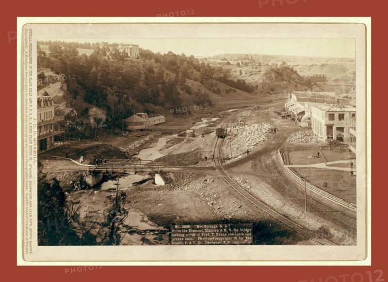 Hot Springs, S.D. From the Fremont, Elkhorn and M.V. Ry. bridge looking north to Fred T. Evans residence and plunge bath, John C. H. Grabill was an american photographer. In 1886 he opened his first photographic studio