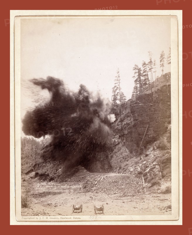 In mid air. A wonderful blast in building railroad to Deadwood, John C. H. Grabill was an american photographer. In 1886 he opened his first photographic studio