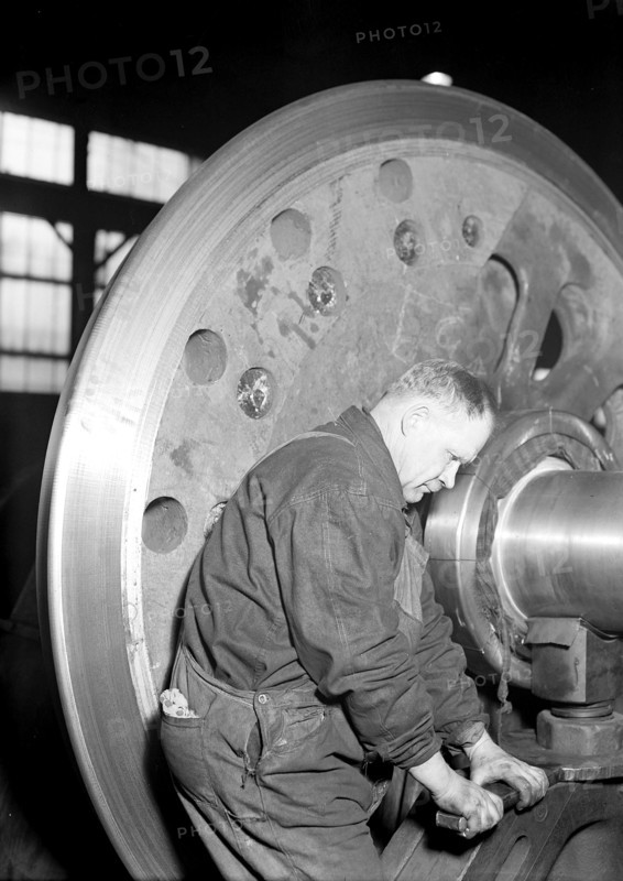 Eddystone, Pennsylvania - Railroad parts. Baldwin Locomotive Works. Machinist finishing axle on large driving wheels (80 inches in diameter) on newest type of locomotive, March 1937, Lewis Hine, 1874 - 1940, was an American photographer, who used his camera as a tool for social reform. US,USA
