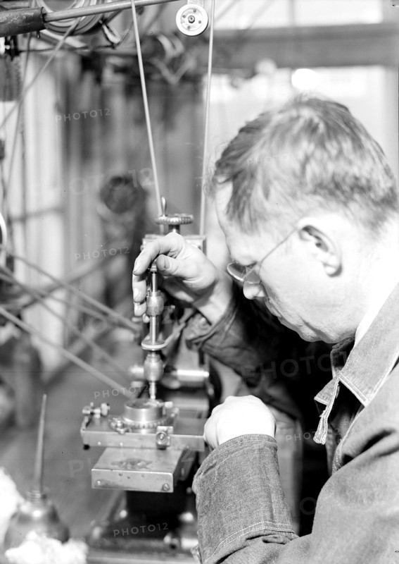 Lancaster, Pennsylvania - Hamilton Watch. Damaskeening - skilled machine operation for putting finishing lines on plates and bridges. A piece of charred ivory is drawn across the plate at proper speed, 1936 , Lewis Hine, 1874 - 1940, was an American photographer, who used his camera as a tool for social reform. US,USA