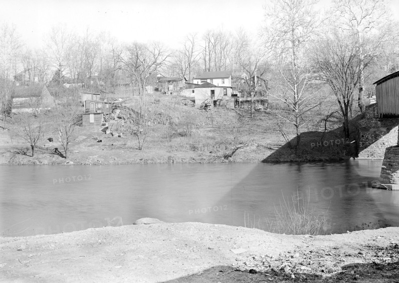 Lancaster, Pennsylvania - Housing. Sunnyside - near covered bridge over Conestoga Creek - dump on one side - shacks on opposite bank - miscellaneous low-paid workers, 1936, Lewis Hine, 1874 - 1940, was an American photographer, who used his camera as a tool for social reform. US,USA