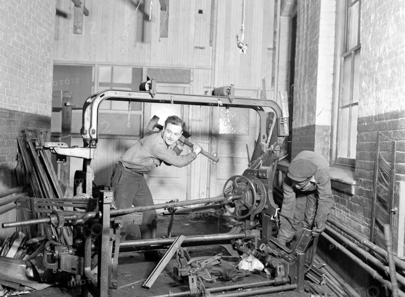 Paterson, New Jersey - Textiles. Junkies breaking up old looms, to be sold for scrap-iron and said to be sent to Japan for munitions, 1936, Lewis Hine, 1874 - 1940, was an American photographer, who used his camera as a tool for social reform. US,USA