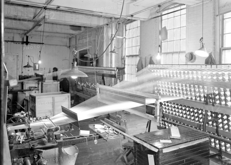Paterson, New Jersey - Textiles. View of threads going from creel throug the reeds and over the roller. Note the use of reeds in bringing threads to coverge to a very narrow breadth as they go over the roller, March 1937, Lewis Hine, 1874 - 1940, was an American photographer, who used his camera as a tool for social reform. US,USA