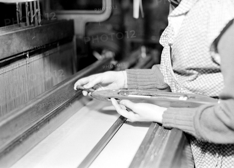 Paterson, New Jersey - Textiles. Weaver threading shuttle, March 1937, Lewis Hine, 1874 - 1940, was an American photographer, who used his camera as a tool for social reform. US,USA