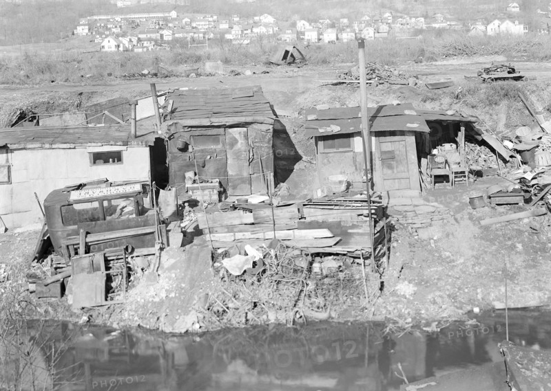 Paterson, New Jersey - Textiles. Bachelor shacks in outskirts of Paterson, on Molly Jan Brook. About 20 men live there now (some of them old silk workers) and stay up there all winter. Man in one view worked in silk up to 5 years ago. On relief now, March 1937, Lewis Hine, 1874 - 1940, was an American photographer, who used his camera as a tool for social reform. US,USA