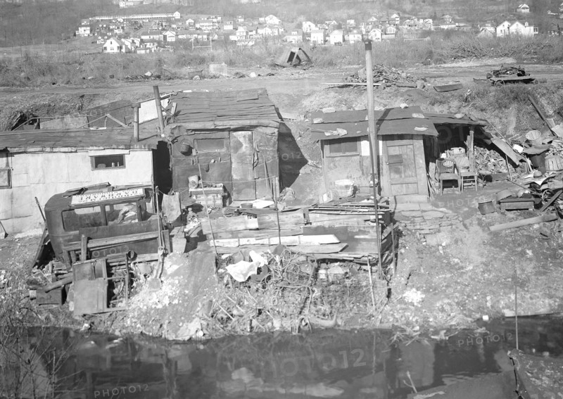 Paterson, New Jersey - Textiles. Bachelor shacks in outskirts of Paterson, on Molly Jan Brook. About 20 men live there now (some of them old silk workers) and stay there all winter. Man in one view worked in silk up to 5 years ago. On relief now, March 1937, Lewis Hine, 1874 - 1940, was an American photographer, who used his camera as a tool for social reform. US,USA