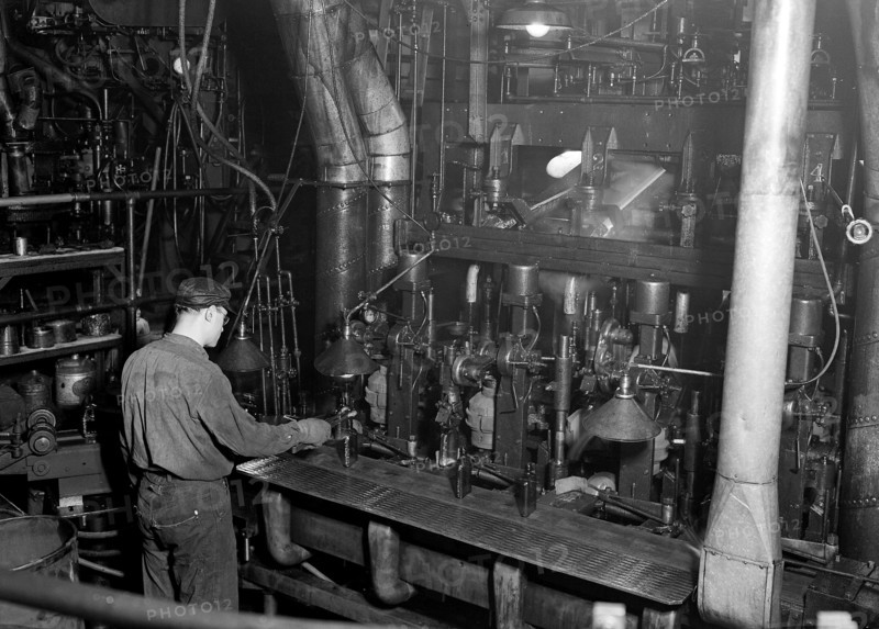 Millville, New Jersey - Glass bottles. Whitall Tatum Co. Second shot of a worker taking a bottle of of an I. S. automatic blowing machine for testing, March 1937, Lewis Hine, 1874 - 1940, was an American photographer, who used his camera as a tool for social reform. US,USA