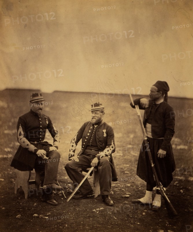 Two French officers, seated, and Zouave, standing with arm resting on rifle, Crimean War, 1853-1856, Roger Fenton historic war campaign photo
