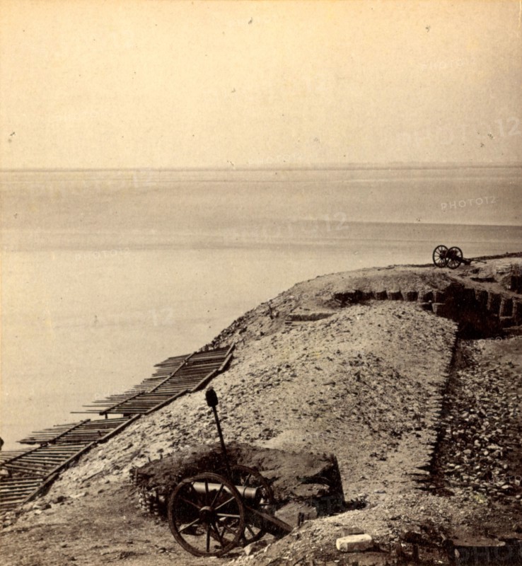 A parapet of Fort Sumpter (i.e. Sumter), looking toward Morris Island. Fort Sumter is a Third System masonry sea fort located in Charleston Harbor, South Carolina. The fort is best known as the site upon which the shots that started the American Civil War were fired, at the Battle of Fort Sumter on April 12, 1861. , Vintage photography