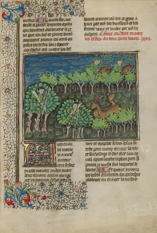 Camouflaged Hunters Preparing to Attack a Deer