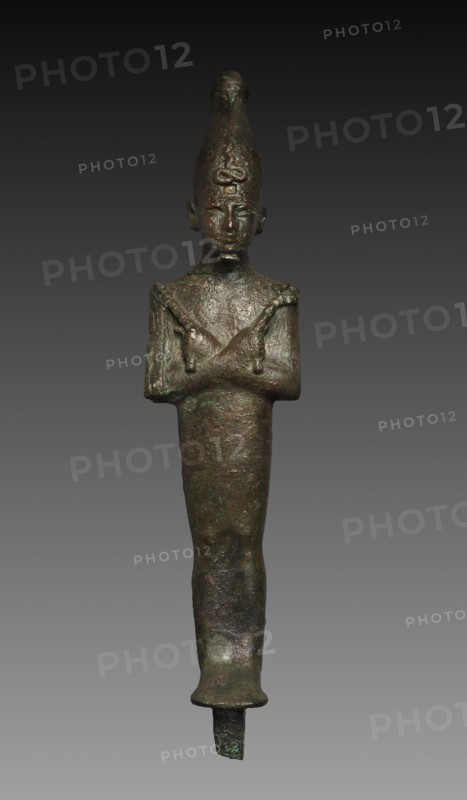 Statuette of Osiris, 664-525 BC. Egypt, Late Period, Dynasty 26 or later. Black copper (?), hollow cast; overall: 6.8 x 4.7 cm (2 11/16 x 1 7/8 in.); with tang: 30.6 cm (12 1/16 in.); without tang: 28 cm (11 in.).