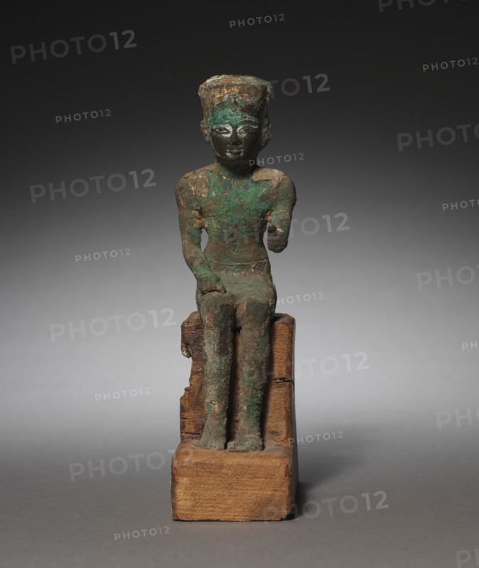 Statuette: Seated Amen-Ra, 715-525 BC. Egypt, Late Period, Dynasty 25-26 (?). Bronze and black copper, gilded and inlaid; overall: 19 x 5.5 x 11.5 cm (7 1/2 x 2 3/16 x 4 1/2 in.).