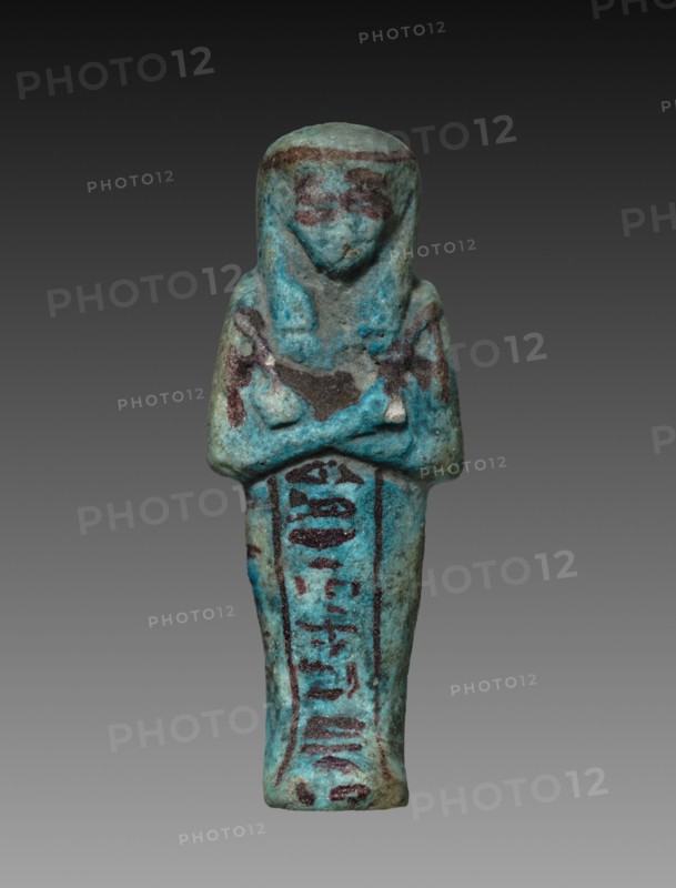 Shawabty of Tanetosorkon, 1000-945 BC. Egypt, Third Intermediate Period, late Dynasty 21 (1069-945 BC). Turquoise faience with purple decoration; overall: 10.5 x 3.9 x 2.6 cm (4 1/8 x 1 9/16 x 1 in.).