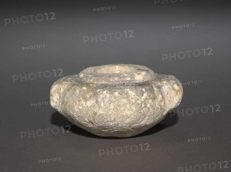 Squat Dummy Jar with Lug Handles, 2770-2573 BC. Egypt, Probably Saqqara, north of the Step Pyramid, excavations of J. E. Quibell, 1910-1911, Predynastic, Dynasties 2-3, 2770-2573 BC. Sandstone; diameter: 7.4 cm (2 15/16 in.); diameter of mouth: 2.5 cm (1 in.); overall: 3.5 cm (1 3/8 in.).
