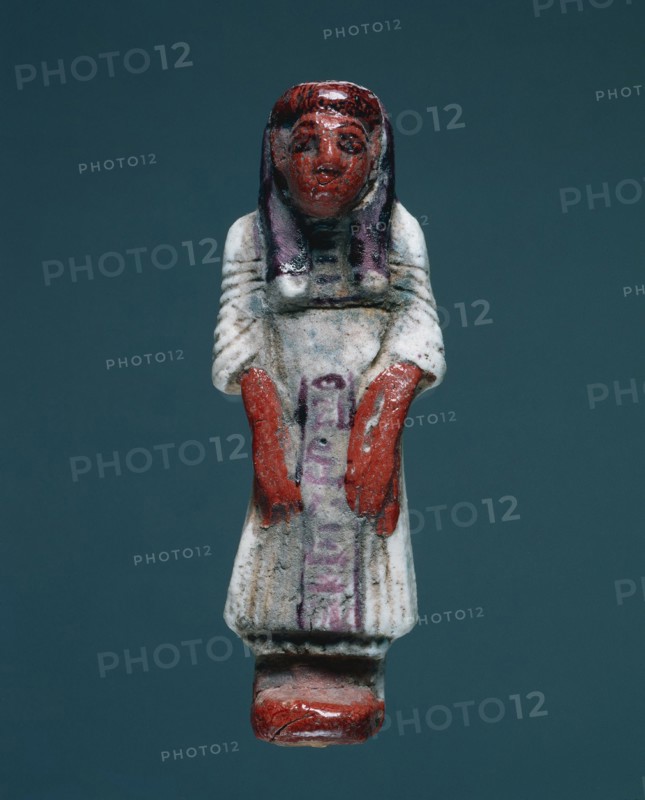 Shawabty in Dress of Everyday Life, 1295-1186 BC. Egypt, New Kingdom, Dynasty 19. Polychrome faience; overall: 13.5 x 5 x 3.2 cm (5 5/16 x 1 15/16 x 1 1/4 in.).
