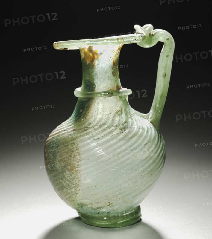 Pitcher with Handle, 300s. Eastern Mediterranean, Roman, 4th century. Glass; diameter: 7.5 cm (2 15/16 in.); overall: 16 x 11.5 x 10 cm (6 5/16 x 4 1/2 x 3 15/16 in.); diameter of foot: 5.5 cm (2 3/16 in.).