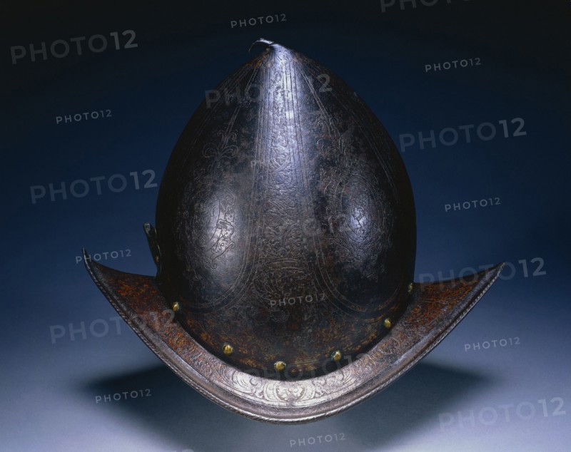 Peaked Morion, c. 1580-1590. North Italy, Milan?, 16th century. Etched russet steel with traces of gilding; roped brim, brass plume holder; overall: 35.4 x 23.7 x 26.7 cm (13 15/16 x 9 5/16 x 10 1/2 in.).