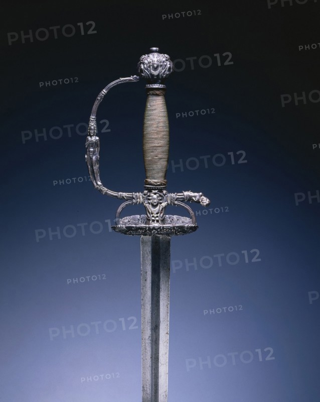 Small Sword with Masks and Figures, c. 1660-1680. Hilt: Holland, blade: Germany, Solingen, 17th century. Steel; chiseling; copper wire; overall: 104 cm (40 15/16 in.); blade: 87.2 cm (34 5/16 in.); grip: 12.5 cm (4 15/16 in.); guard: 7.6 cm (3 in.).