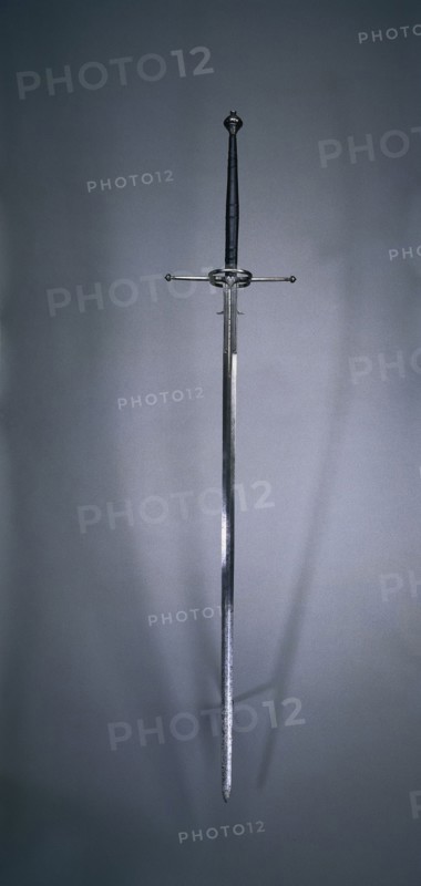 Two-Handed Sword, 1550-1600. Spain, Toledo (?), second half of 16th Century. Steel, wood and leather grip; overall: 167.3 cm (65 7/8 in.); blade: 126 cm (49 5/8 in.); quillions: 31.8 cm (12 1/2 in.); grip: 40 cm (15 3/4 in.); ricasso: 17.2 cm (6 3/4 in.).