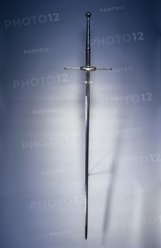 Two-Handed Sword, 1550-1600. Spain, Toledo, second half of 16th Century. Steel, wood and leather grip; fluted pommel; overall: 168.3 cm (66 1/4 in.); blade: 126.4 cm (49 3/4 in.); quillions: 35.2 cm (13 7/8 in.); grip: 41.3 cm (16 1/4 in.); ricasso: 20.3 cm (8 in.).