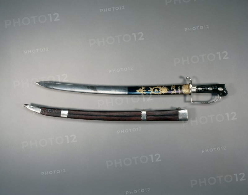 Hunting Sword, 1778-1779. William Kinman (British, 1724-1788?). Blued, etched, and gilded steel; hilt:  silver, wood; overall: 74.9 cm (29 1/2 in.); blade: 60.3 cm (23 3/4 in.); grip: 13.7 cm (5 3/8 in.); guard: 10.8 cm (4 1/4 in.)