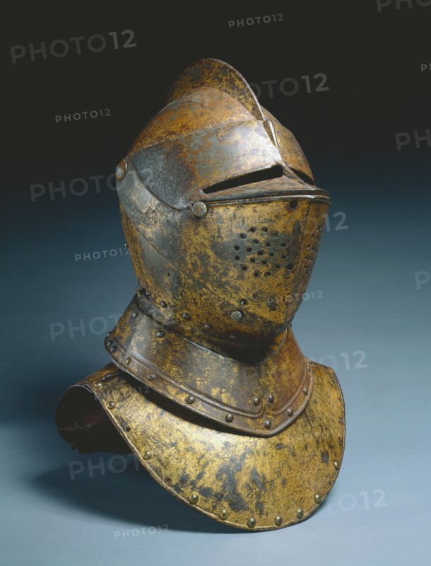 Gorget (from a funerary achievement?), c.1590-1625. Netherlands(?), late 16th-early 17th Century. Gilded steel (invaded with rust); red velvet lining, plume holder; overall: 32.4 x 24.8 x 19.1 cm (12 3/4 x 9 3/4 x 7 1/2 in.).