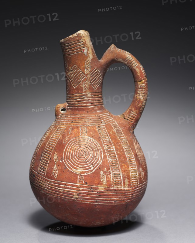 Jug, c. 2000-1800 BC. Cyprus, from Alambra or Ayia Paraskeve, Early Cypriot III-Middle Cypriot I. Red ware; diameter: 10.4 cm (4 1/8 in.); overall: 16.5 cm (6 1/2 in.).