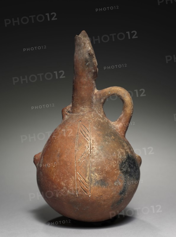 Jug, c. 2000-1800 BC. Cyprus, Early Cypriot III-Middle Cypriot I. Red ware; diameter: 12.5 cm (4 15/16 in.); overall: 22.8 cm (9 in.).