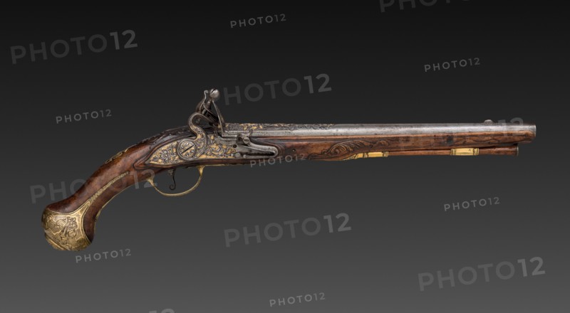 Pair of Flintlock Pistols, early 1700s. Franco-Flemish, Liège, early 18th Century. Steel with gold inlay, gilt-brass mounts; walnut burl stock; chiseled high-relief decoration; overall: 49.5 cm (19 1/2 in.); barrel: 32.1 cm (12 5/8 in.); bore: 1.5 cm (9/16 in.).